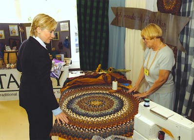 Senator Hillary Clinton admires an Adirondack Rug